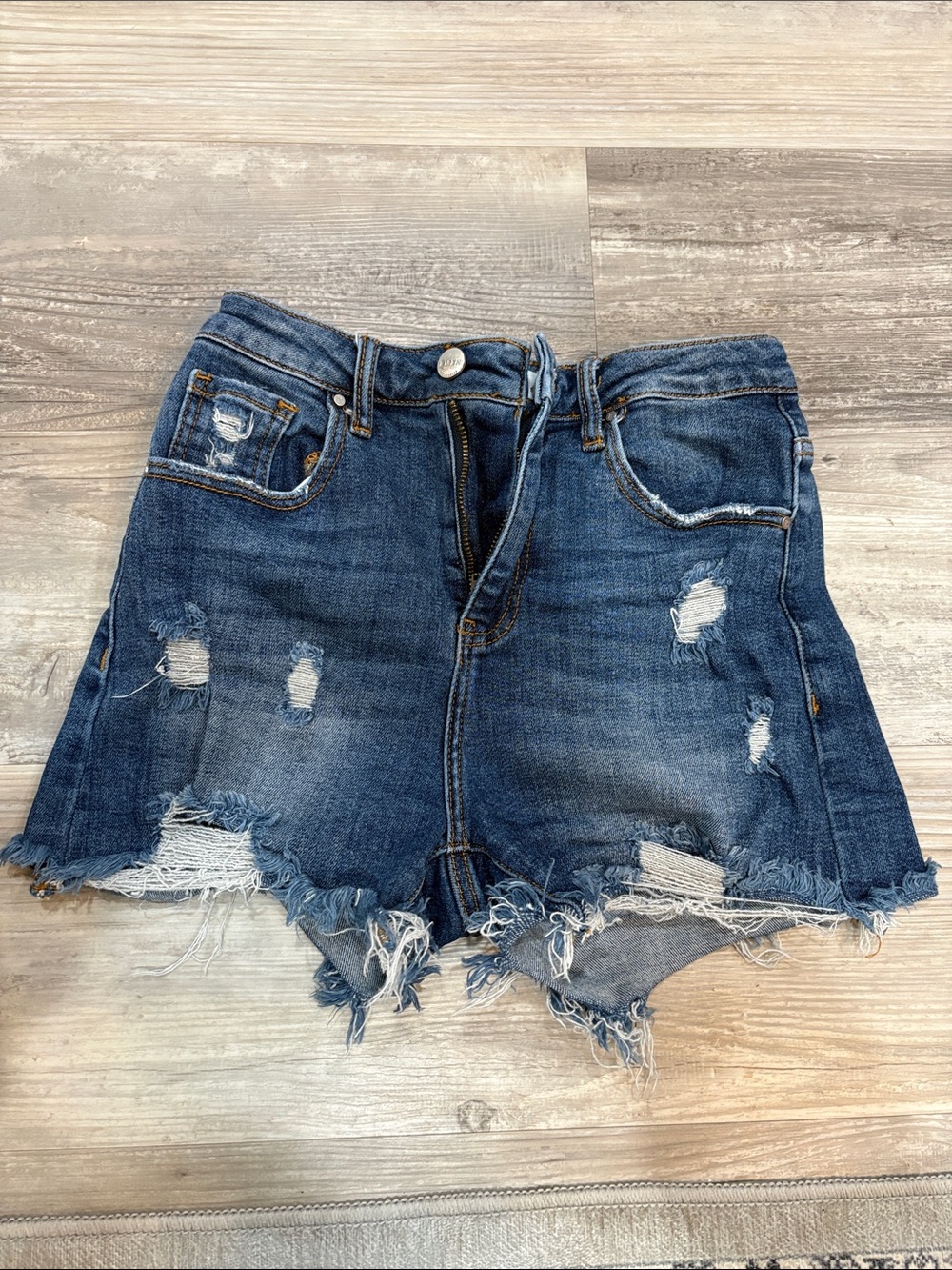High-Rise Distressed Denim Shorts in Blue